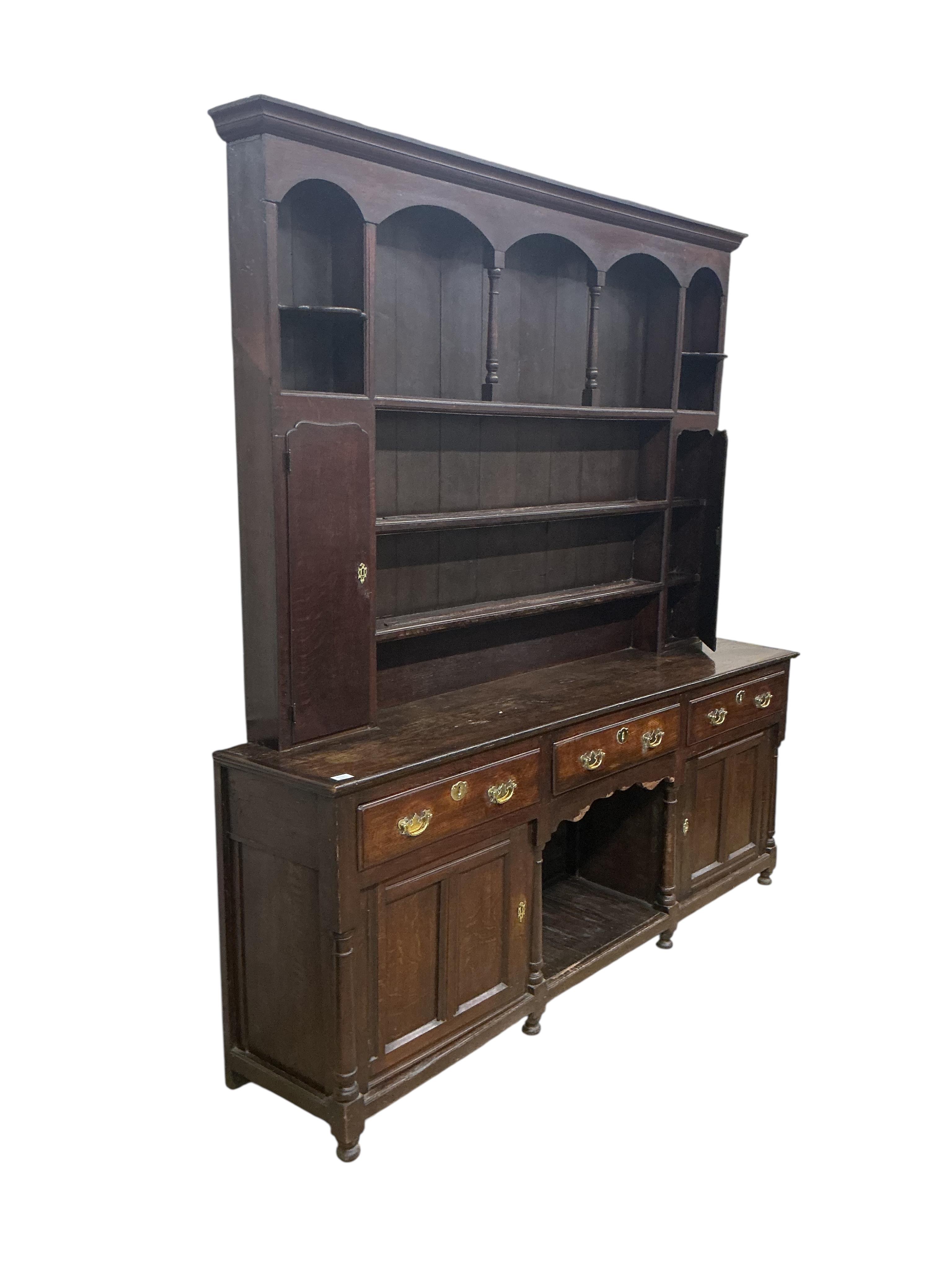 An 18th century and later oak 'dog kennel' dresser with boarded rack, width 216cm, depth 45cm, height 248cm